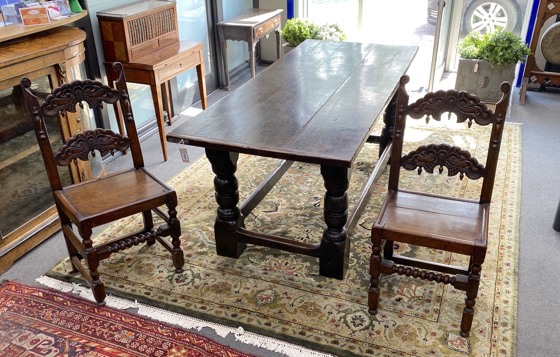 An 18th century and later rectangular oak refectory dining table, length 194cm, width 83cm, height 79cm and two Derbyshire style oak chairs